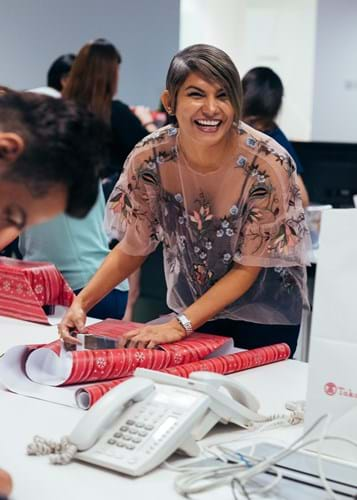 Female WE employee wrapping gift