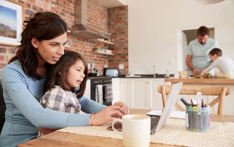 Consumers interacting with laptop at home