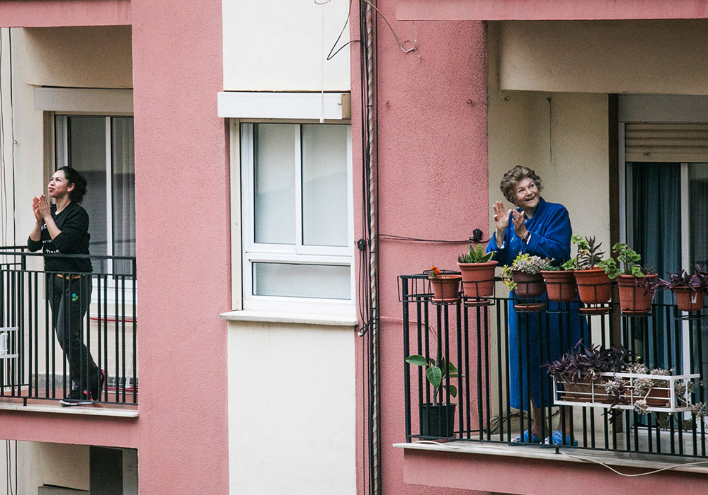 Neighbours clapping for healthcare workers from the power of communications during a crisis