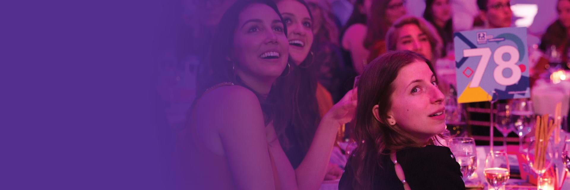 Woman sitting at awards event table