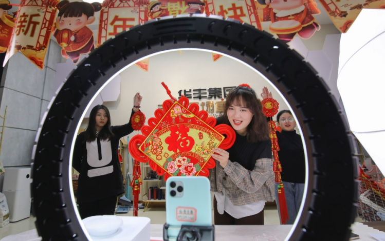 Woman taking photo through tire - What Do Chinese New Year Marketing During Pandemic Look Like Her Image