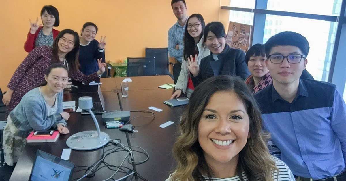 A group of WE employees in a meeting room smiling