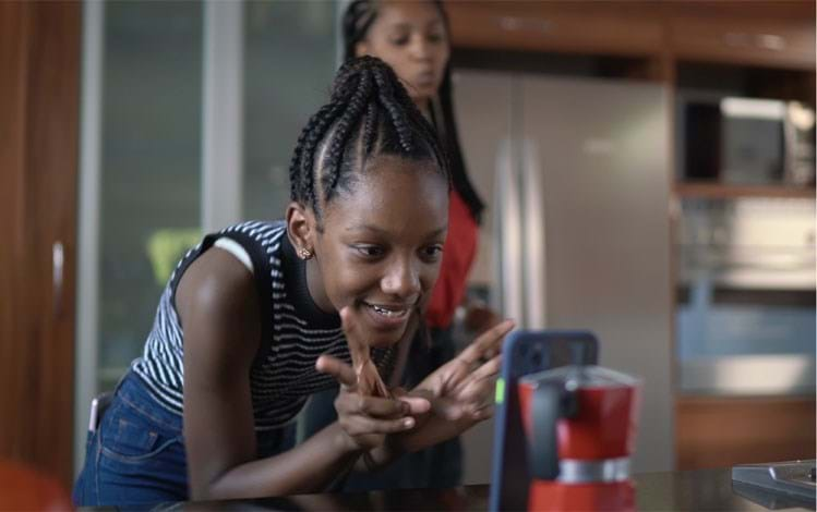 Girl interacts happily with mobile phone - mobile