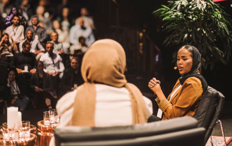 women speaking on stage