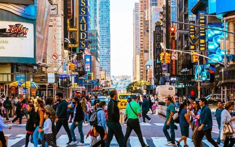 busy street scene of people crossing at a crosswalk