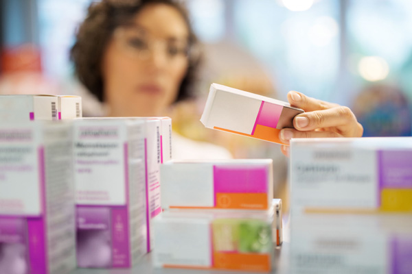 woman looking at medication